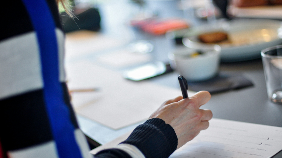 Person sketching wireframes and user flows for Versal Finance